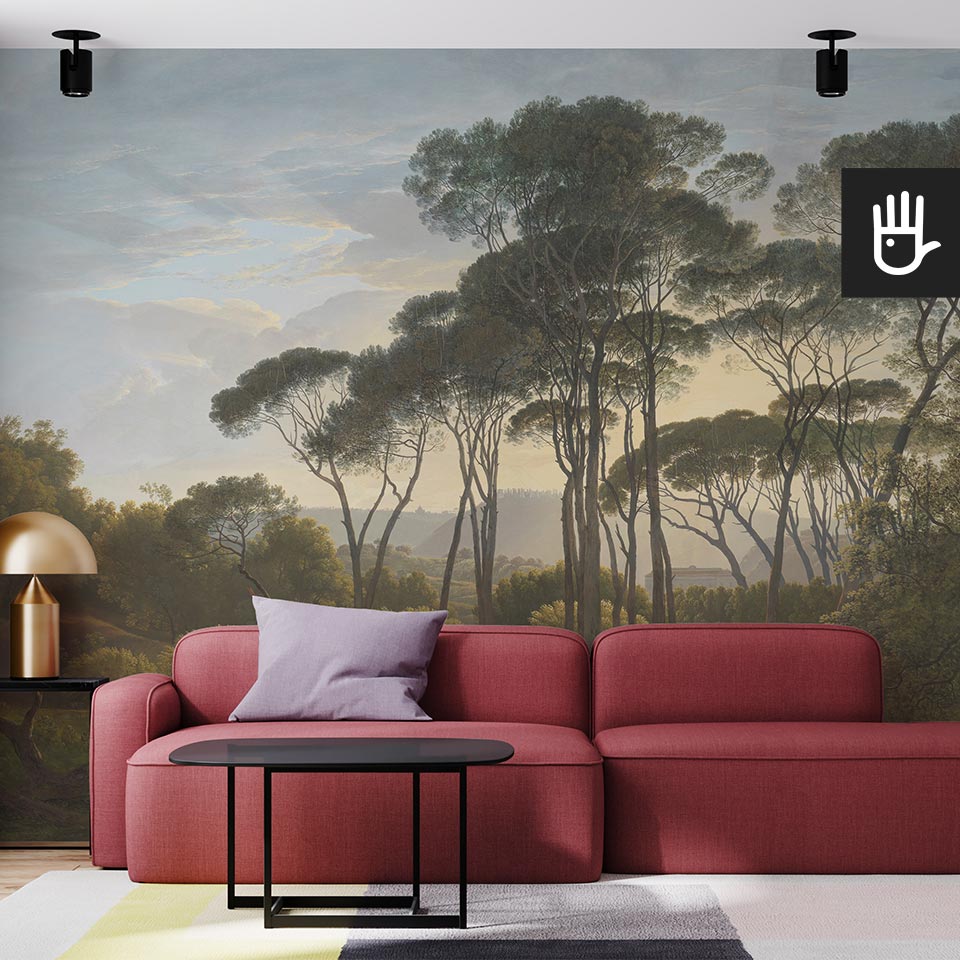 Salon z czerwoną kanapą na tle fototapety z włoskim krajobrazem i drzewami na tle nieba