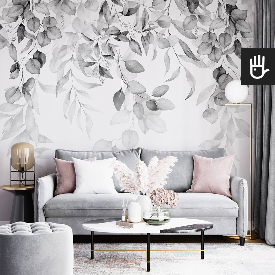 Fototapeta girlanda szarości w czarno-białym kolorze na białym tle na ścianie nowoczesnego salonu z szarą kanapą i poduszkami w kolorze pudrowego różu.