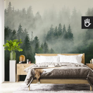 Fototapeta Las we mgle w sypialni w stylu naturalnym eko w górskim klimacie z drewnianym łóżkiem na tle zamglonych gór.